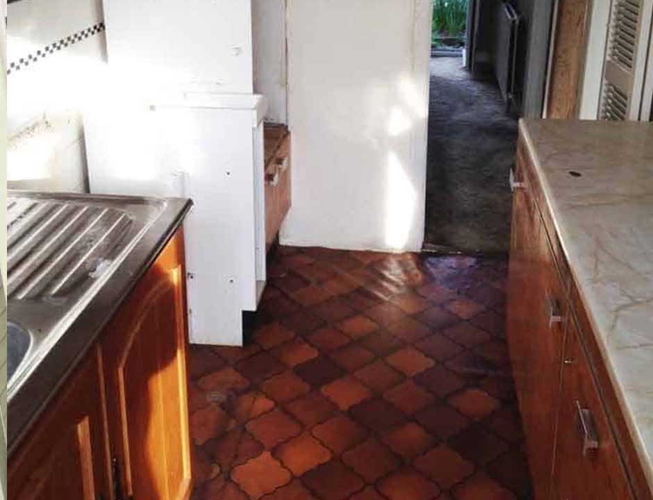 The same kitchen cleared and swept after a house clearance